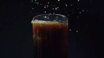 Dropping Ice in Coke in slow motion