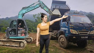 the driver and the girl Operate the excavator, the car.shoveling dirt onto a Ben truck.