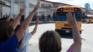 Wadsworth Elementary School teachers in Flagler County wave goodbye to the students as their buses c