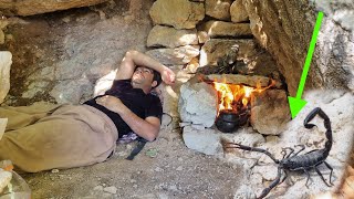 Building a small room under a big rock to protect yourself from the cold and wild animals