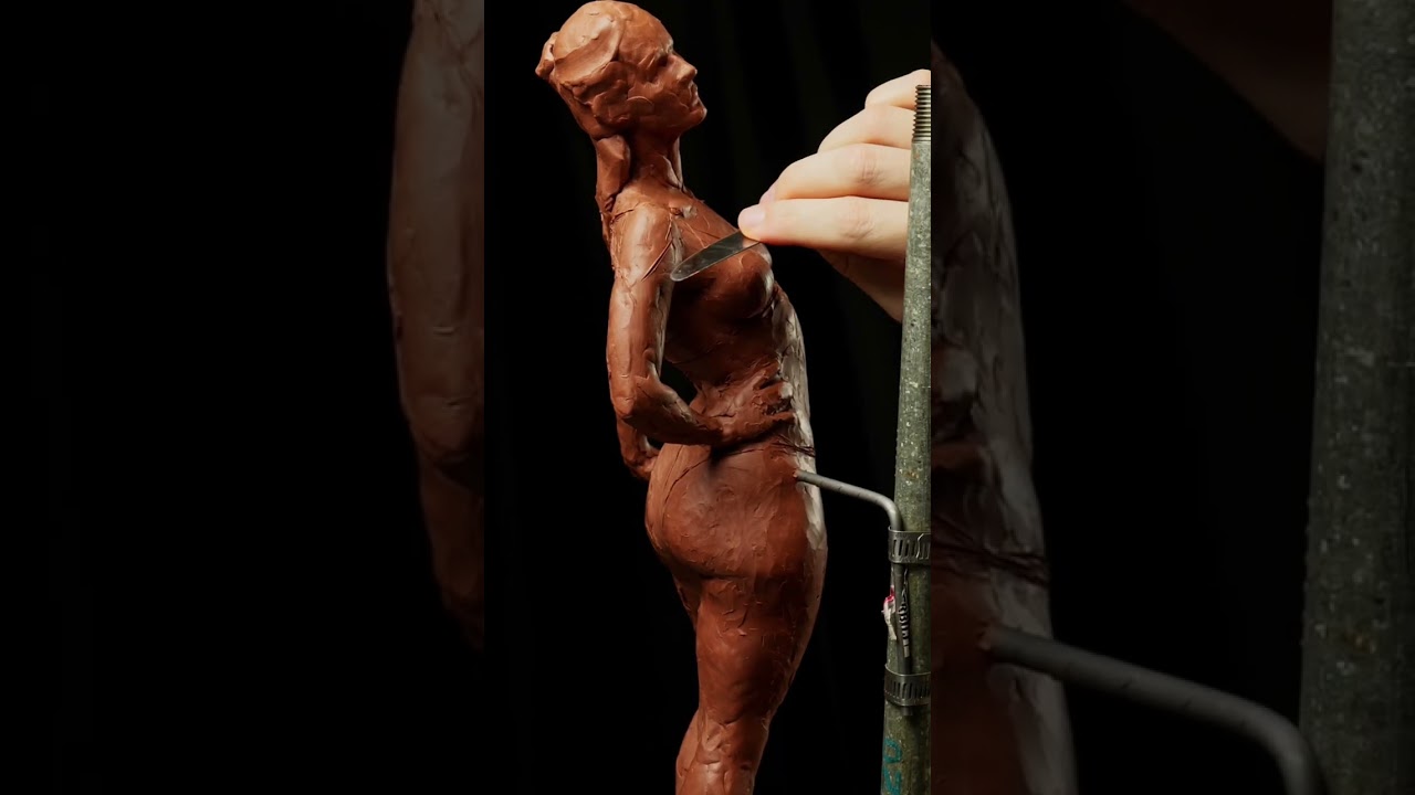 Working on Shoulder Of Female Figure Sculpture In Clay.
