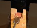 carving a wide square joint groove on a wooden plank surface using a sharp wide flat chisel tool