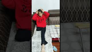 Adorable Chinese RAK one leg amputee girl lying on sofa singing