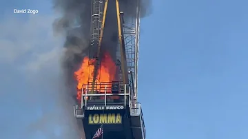 11 injured after burning crane sends debris plummeting to ground below