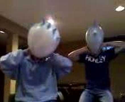 Tim and Steve Blowing up Balloons on their head