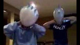 Tim and Steve Blowing up Balloons on their head