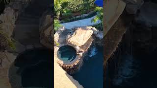 This backyard paradise has it all: a massive grotto, elevated spa, upper and lower pools