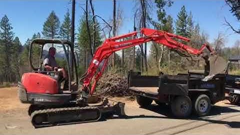 KX-91-3 loading in a 6x10 load trail dump trailer