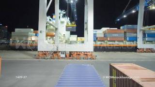 Time-lapse of crane unloading container ship with help from straddle carriers, New Zealand