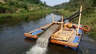 GOLD AND DIAMOND DREDGER IN OPERATION.