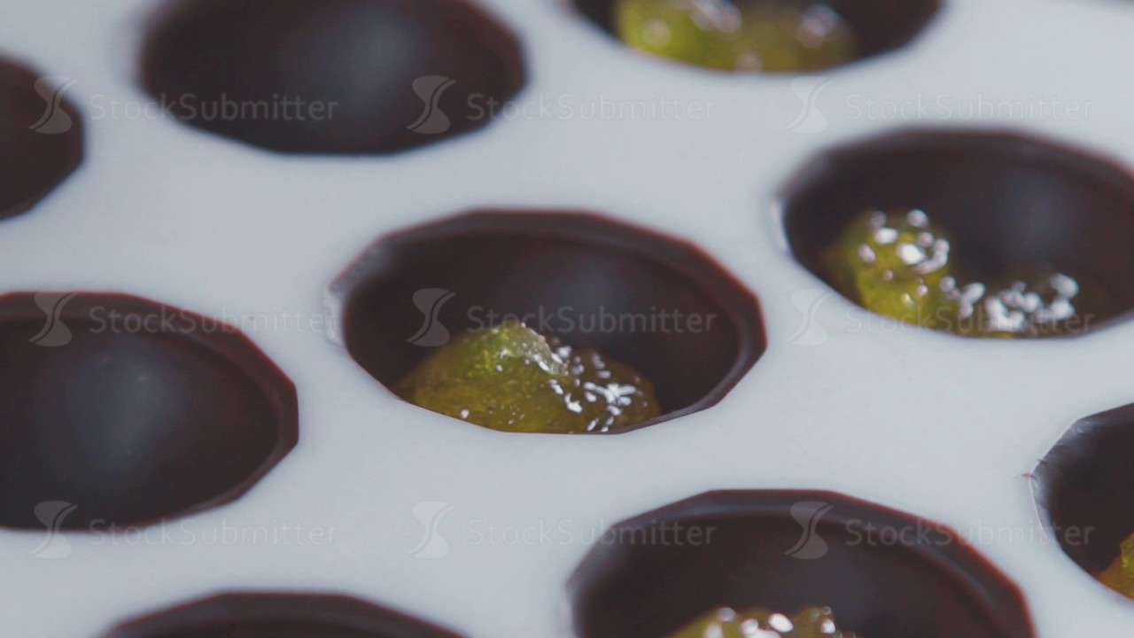 Making chocolates. Introduction orange fillings in chocolate mold YouTube
