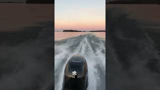 2022 df115 Suzuki outboard cruising at moonrise