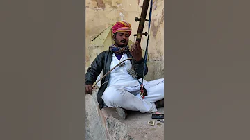 Indian street performer with a  traditional music instrument