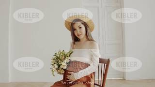 Beautiful pregnant asian woman sits on chair and poses in room in daytime