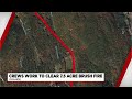 Orange first responders work to clear brush fire