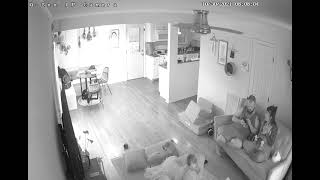 Little boy stand on couch then falls back and Dad catches him with his legs/feet (Security camera)