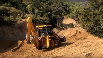 JCB Backhoe 3DX Machine Adjusting The Soil Level on The Hilly Road
