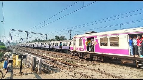 Crossing : Different Model Of EMU Local Trains Parallel Crossed a busy Railgate