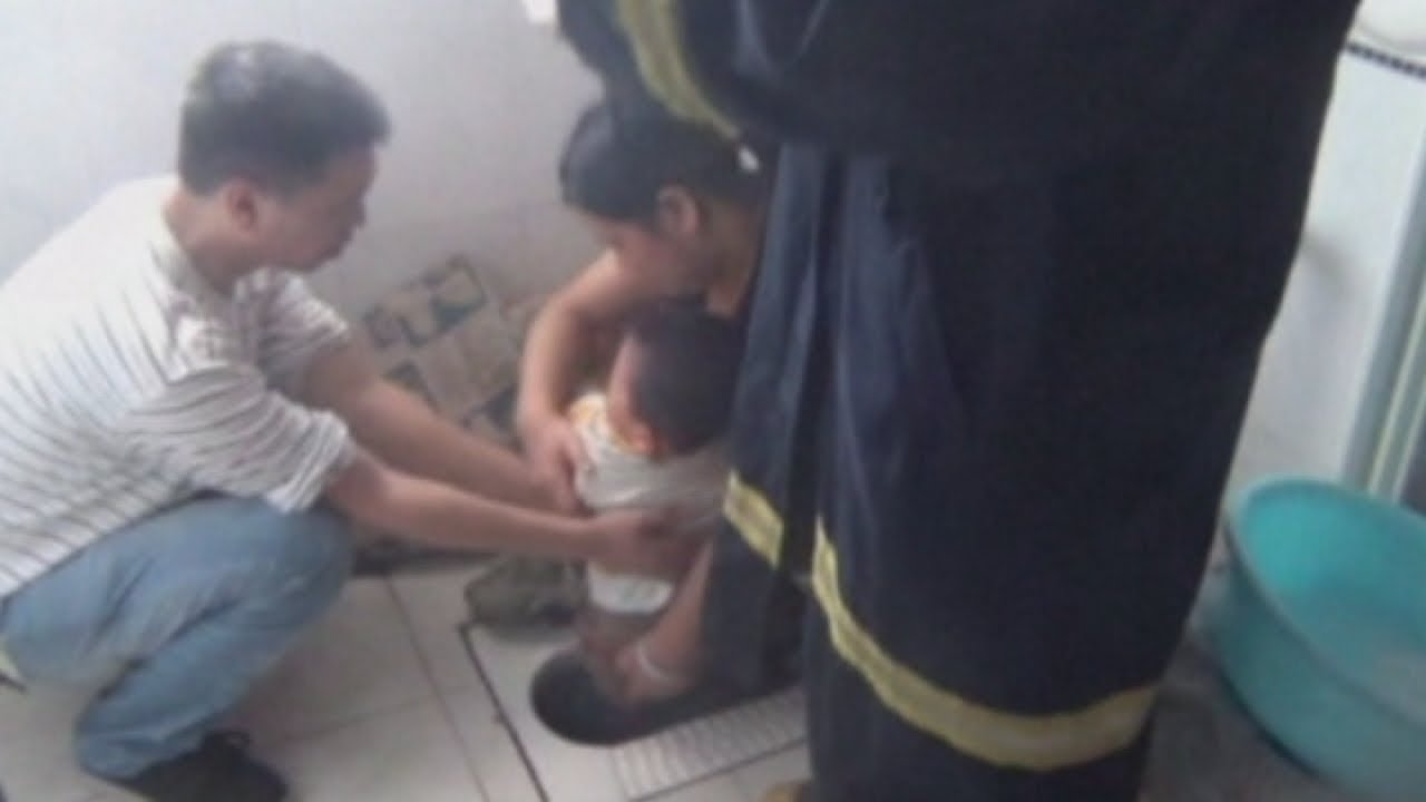 China Boy gets stuck in squat toilet pic