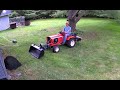 1974 allis chalmers 712h tractor dumping with a modified swisher dump bucket and rototiller