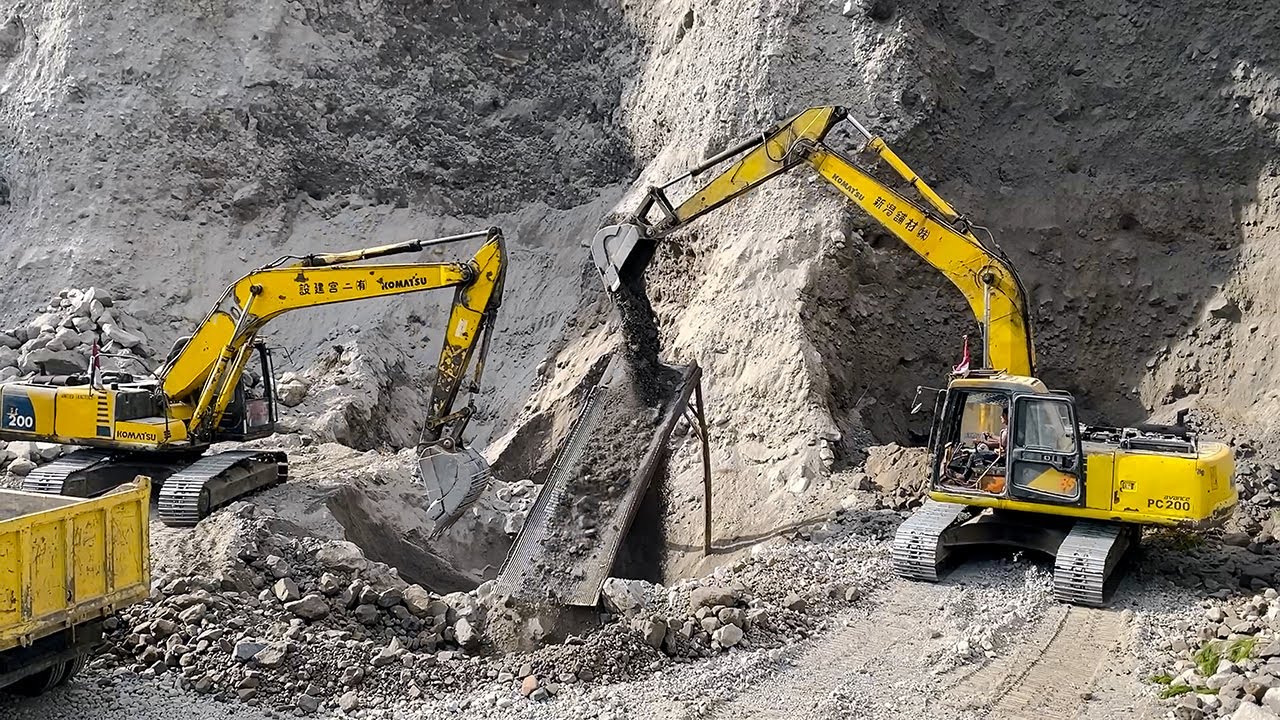 Twin Komatsu PC200 Excavators Loading Mitsubishi Trucks Sumatera