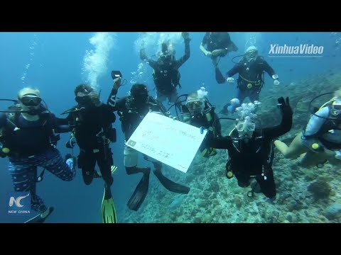 Maldivian divers send wishes for China from underwater