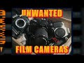 A box of broken film cameras