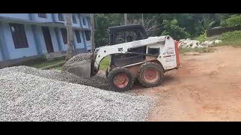 metal loading to tipper with bobcat loader