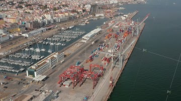 Aerial view of cargo containers in industrial cargo port by the sea near city center of Lisbon