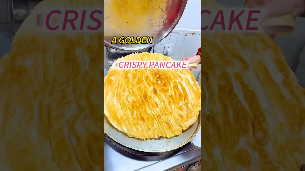 A golden, crispy pancake served with sauce