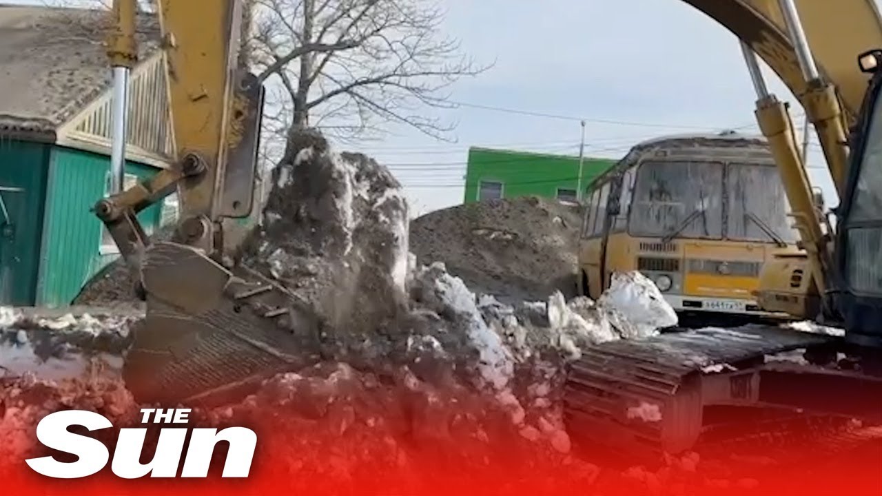 Crews clear HUGE piles of ash in Russian villages in wake of volcanic eruption