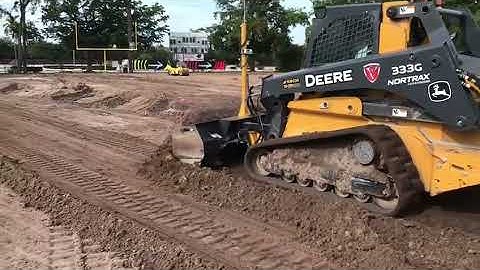 Deere CTL with V-Loc System grading a football field