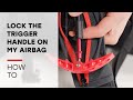 How do I lock the trigger handle on my ARVA airbag backpack?