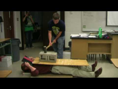 Physics Teacher Hit with Sledge Hammer While on Bed of Nails?!