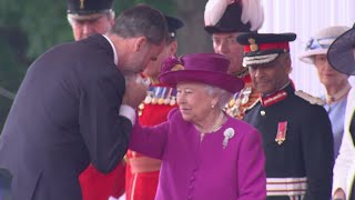 The King of Spain greets the Queen with a kiss