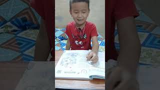 Ishank gharti is reading his class two book