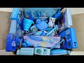 Box full of cute blue stationery items- geometry box, feather pen, pencil sharpener, eraser, bottle
