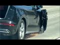 Car tears down freeway on 3 wheels with open tailgate