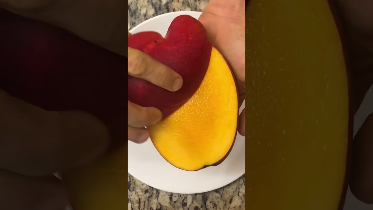 Slicing a red Haden Mango