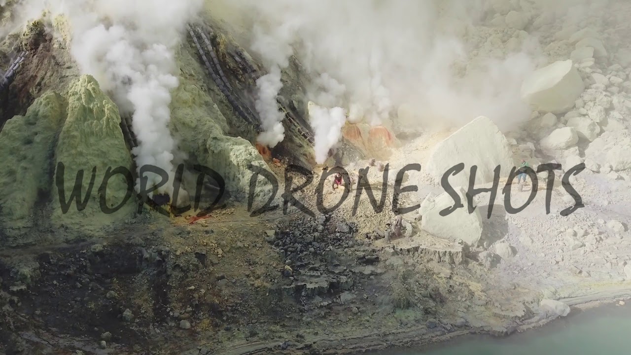 Drone shot moving in on miners working at crater bottom, Ijen volcano (Kawah Ijen), East Java 4k