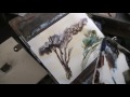 Using a plastic card to create rocks and texture in watercolour