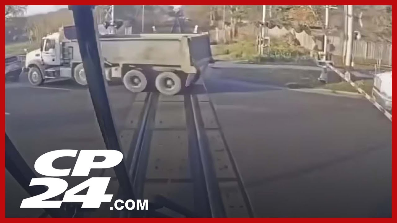 GO Train hits dump truck stopped on tracks - YouTube
