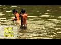 Boys cool off in the water along Rajpath, New Delhi