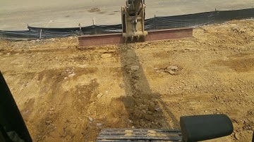 Grading dirt / soil with a steel beam