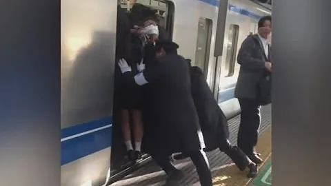 Professional Pushers Shove Passengers Onto Busy Tokyo Train