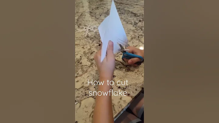 7 year old making paper snowflakes