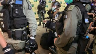 Images of a young woman being arrested by the police as protesters
march in hong kong. people took to streets demonstrate and mark
one-year annive...