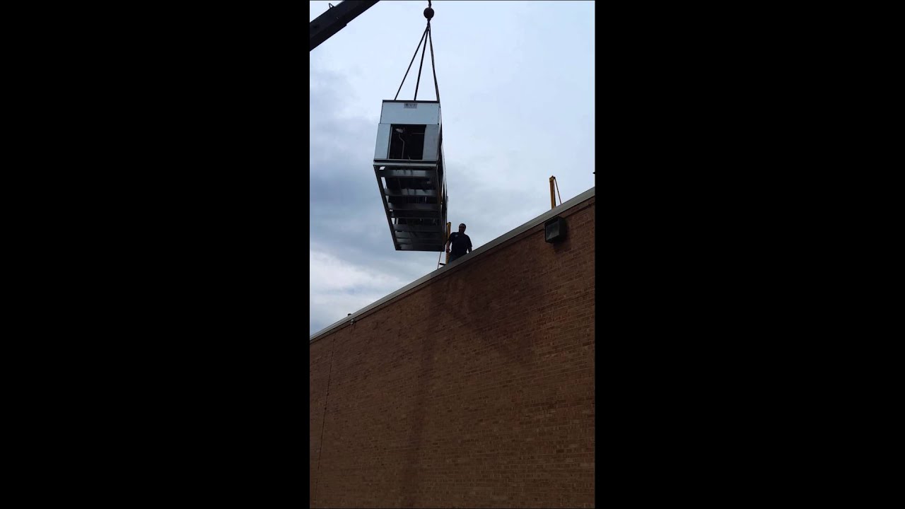 Cooling Equipment Service, Inc. Crane lifting up refrigeration unit
