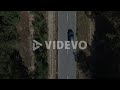 Copter view car riding on road at forest