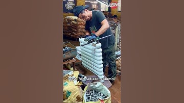 The workers are assembling the cast iron radiator column wings